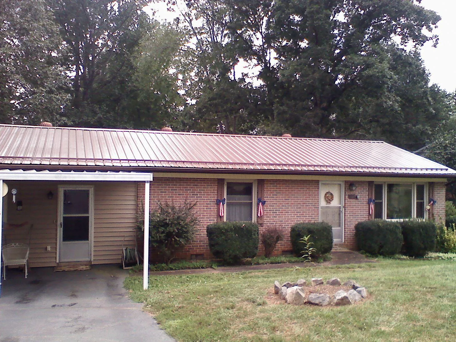 Bronze metal roof and carport on a brick ranch home — Roof Repair work by our crew in York Harbor