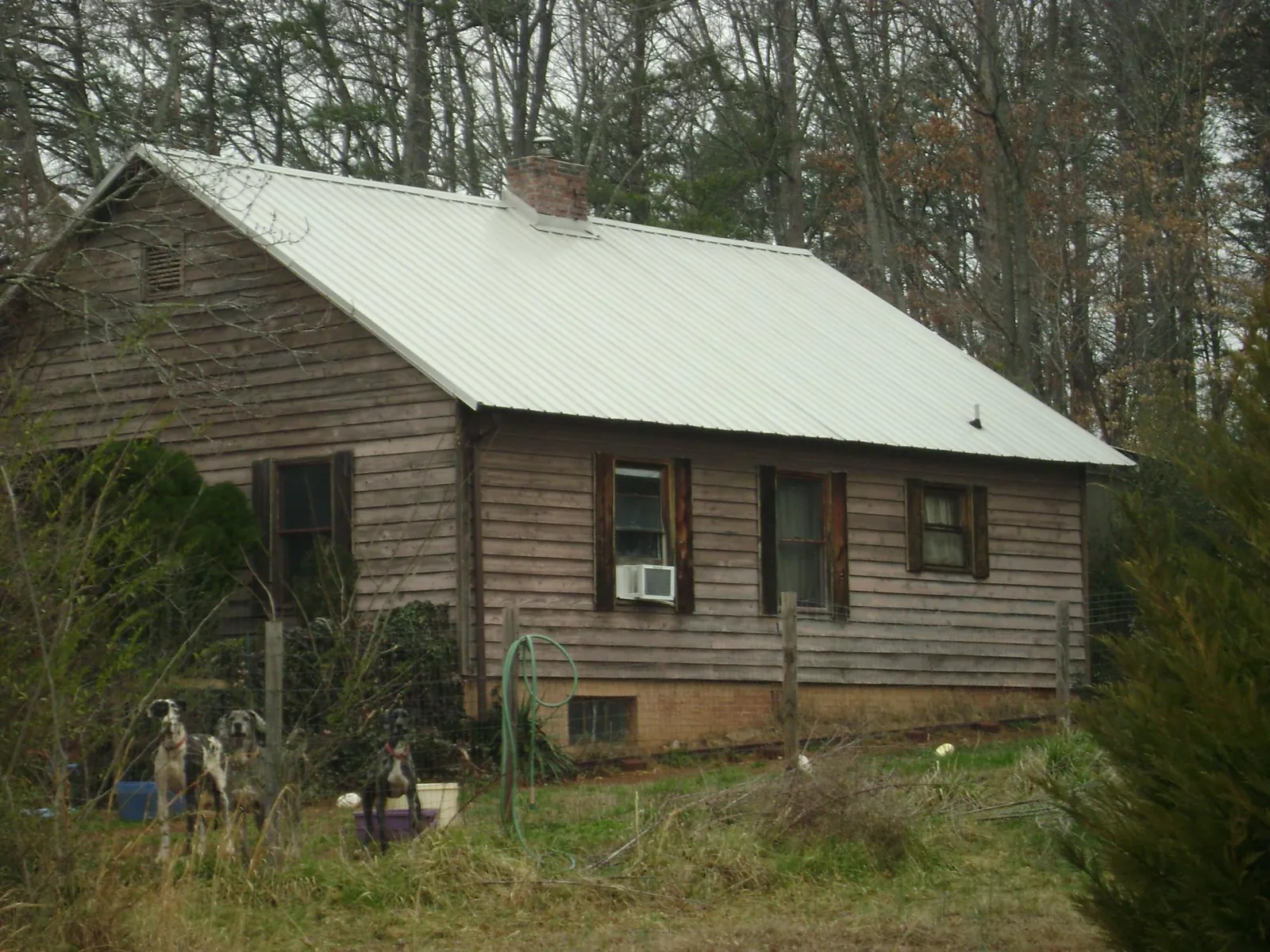 White metal roof on an old wood sided farmhouse, from a Asphalt Shingle Roof Repair job in York Harbor